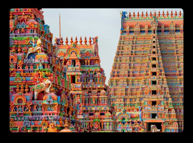 A vibrant, intricately carved temple tower from the Trichy region showcasing rich cultural architecture