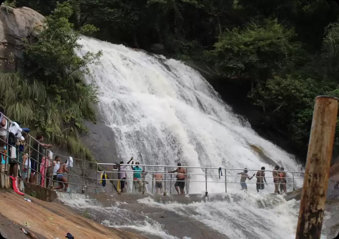 Mini Falls with Gentle Water Flow in Kolli Hills Viewpoint Mini Falls flowing smoothly over wide rocks with visitors enjoying the refreshing scenic spot in Kolli Hills