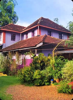 Traditional Homestay Surrounded by Garden and Local Charm Peaceful homestay with tiled roof and garden space reflecting local culture and warm hospitality